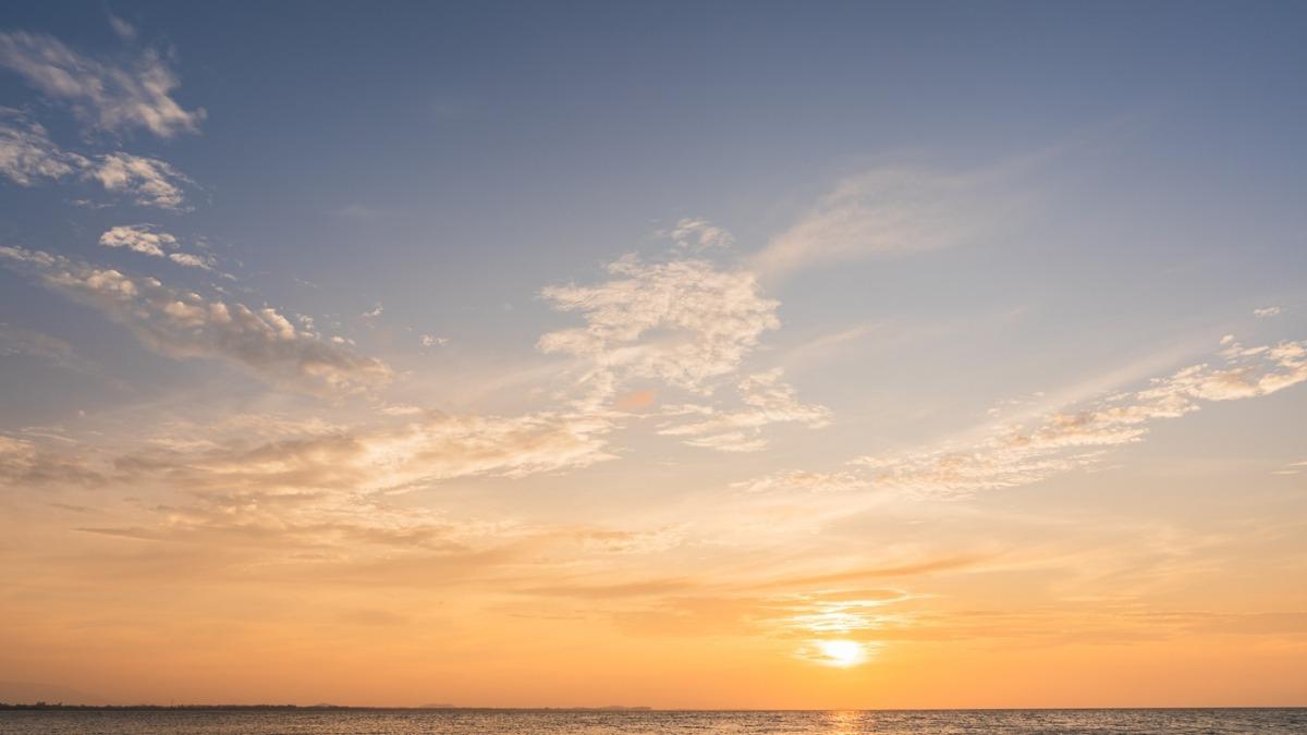 sunset sky, clouds golden hour over the atlantic ocean with blue, pinks, and purples.