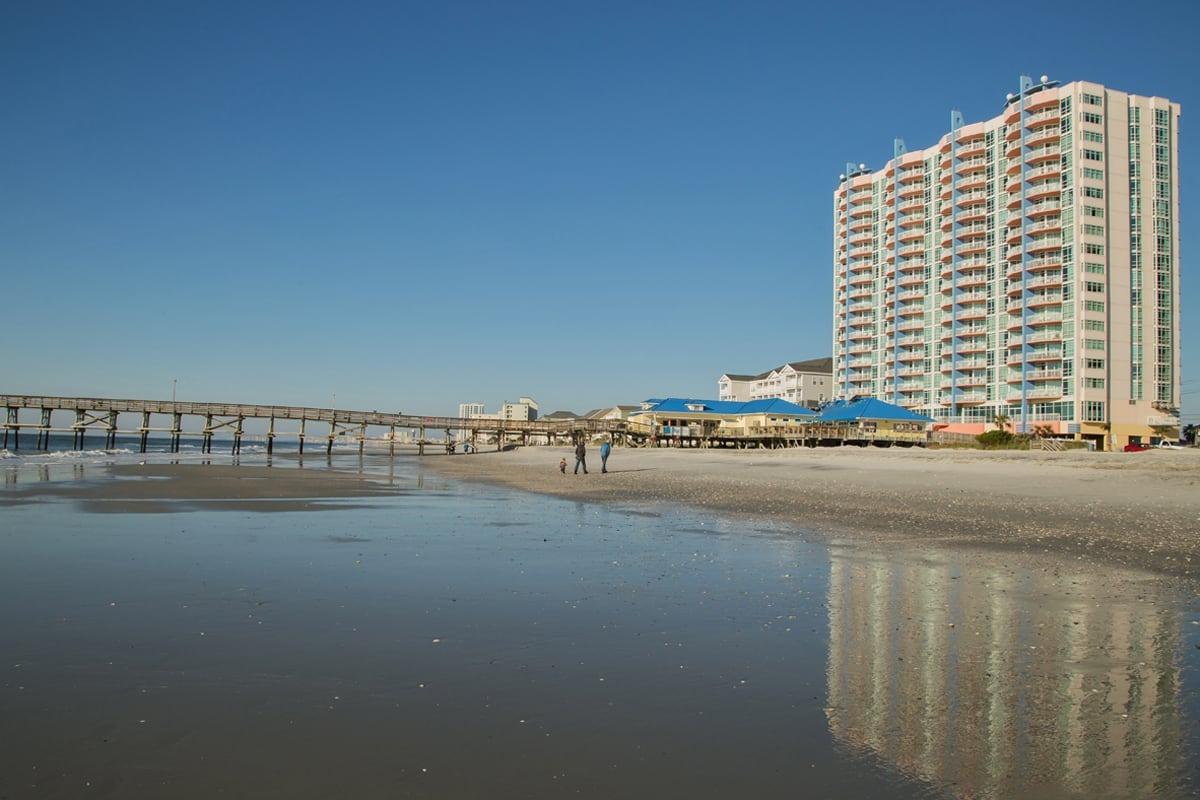 picture of prince resort showing the beach, cherry grove fishing pier, and clear blue skies