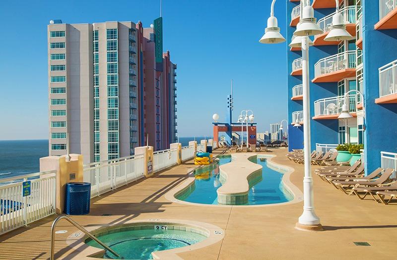 View of the rooftop swimming pool and lazy river at Prince Resort with the ocean in the distance