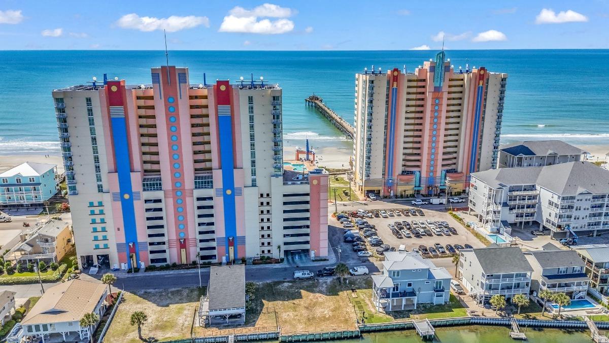Prince Resort oceanfront towers in Myrtle Beach with Cherry Grove Pier in the background, offering ideal lodging for visitors attending the Myrtle Beach Jeep Jam.